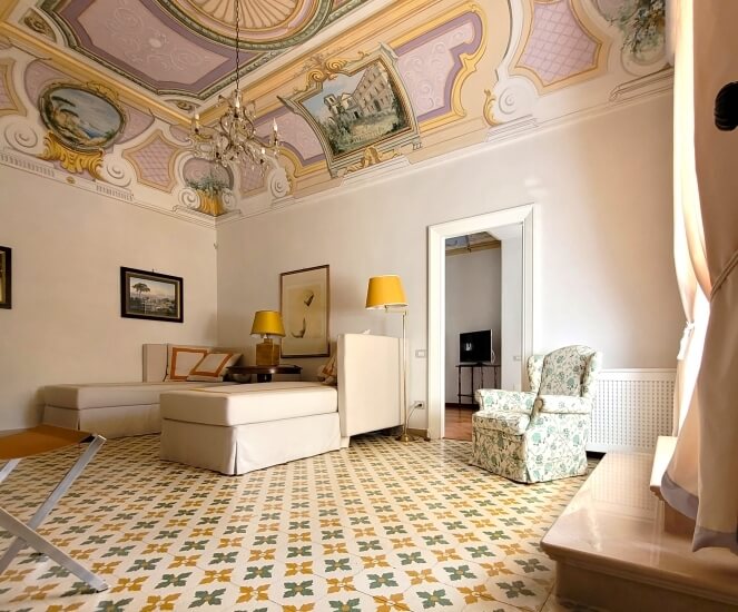 elegant room with sofas and frescoes 