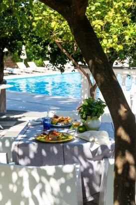 table with food with pool next to it