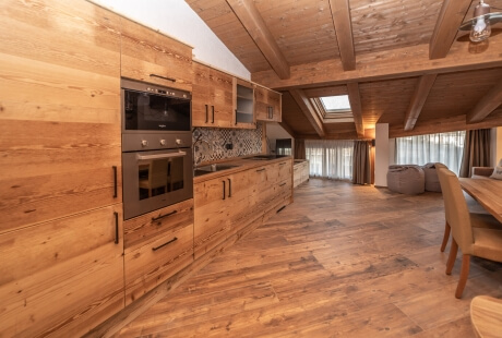 Spacious room with kitchenette, dining area, and living space featuring light wood accents and modern amenities.