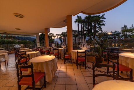 Serene dining area with warm lighting, elegant furniture, and a garden view, creating a cozy atmosphere for socializing.