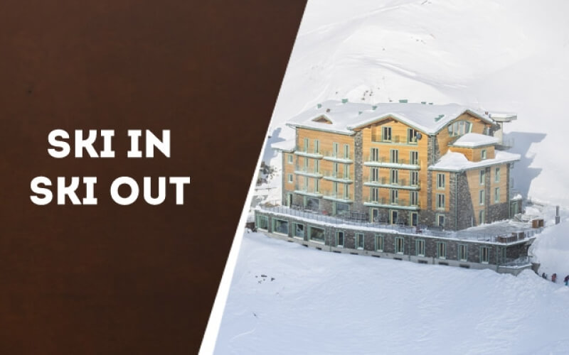 Left: "SKI IN SKI OUT" in bold white on dark brown. Right: large building in a snowy landscape.