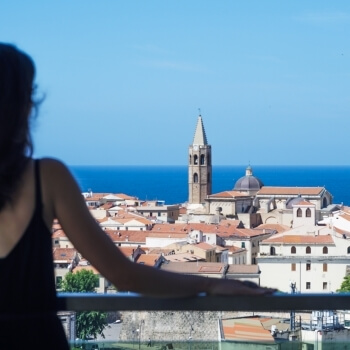 Girl looks the Alghero's downtown from the Skybar