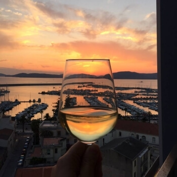 Colors of the sunset in a goblet of wine