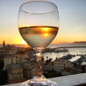 Reflex of Alghero in a glass of wine