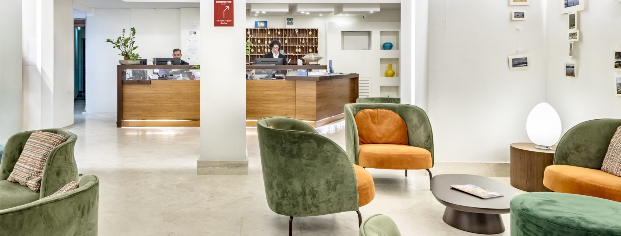 Hotel reception area with desks, seating, and decorative elements.