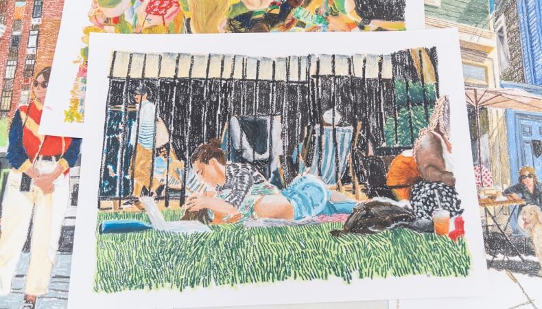 Pastel drawings: person on grass with laptop, fence, and building.