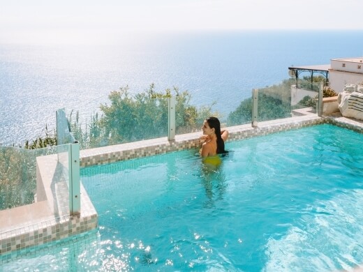 swimming in the pool with a sea view