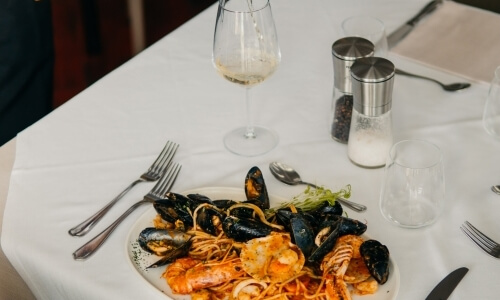 Plate of seafood pasta with mussels, shrimp, and scallops.