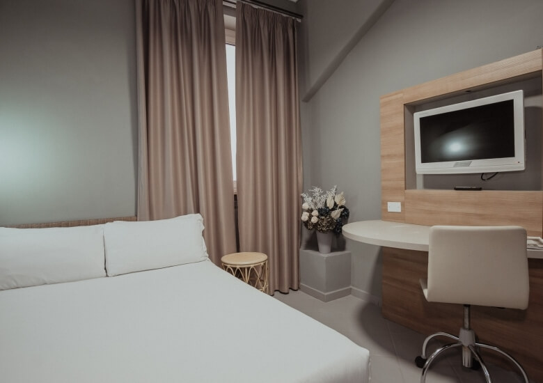 room with double bed and desk