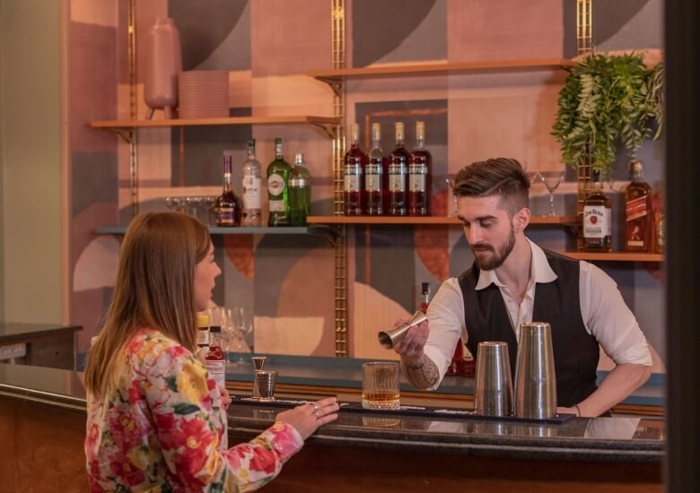 bar hotel milani rome with barman and customer