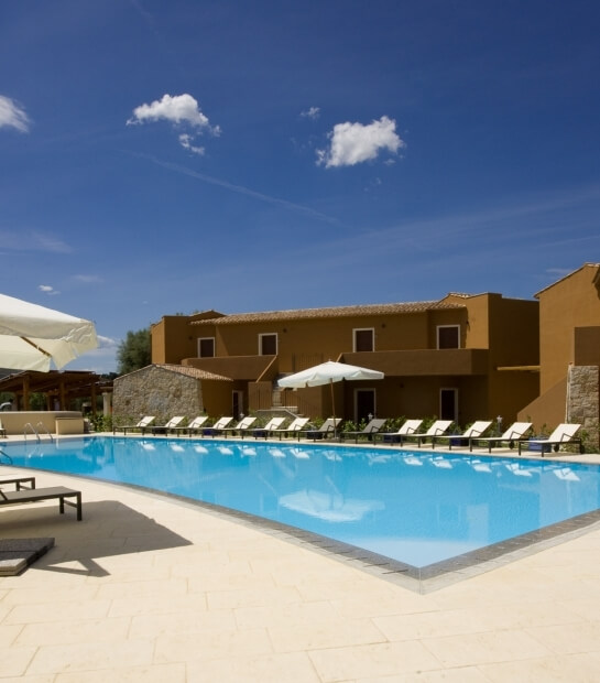 swimming pool with sun loungers 