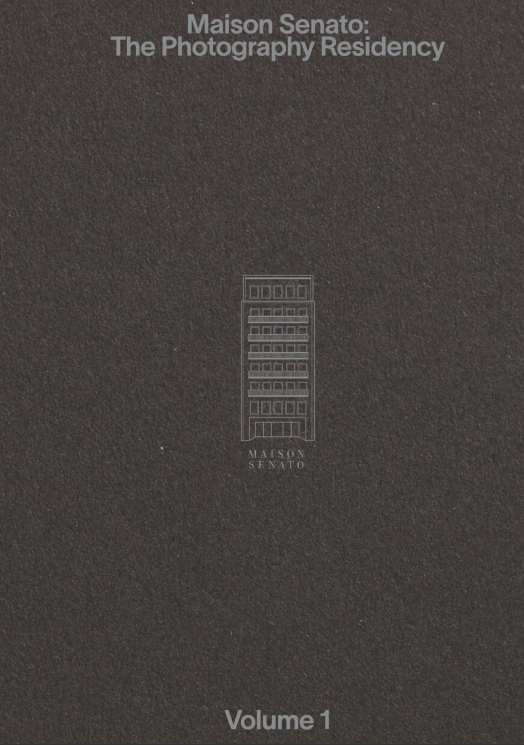 Cover of "Maison Senato: The Photography Residency," Volume 1, featuring a building illustration on a dark gray textured background.