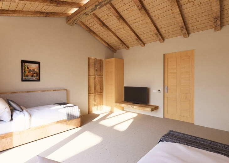 Interno di una camera con travi a vista e arredo in legno.