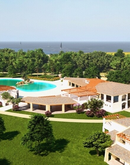 Resort view with buildings, pool, gardens, and ocean in background.   Vista del resort con edifici, piscina, giardini e mare sullo sfondo.