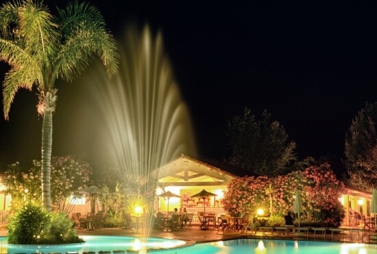 Resort lights illuminate the pool