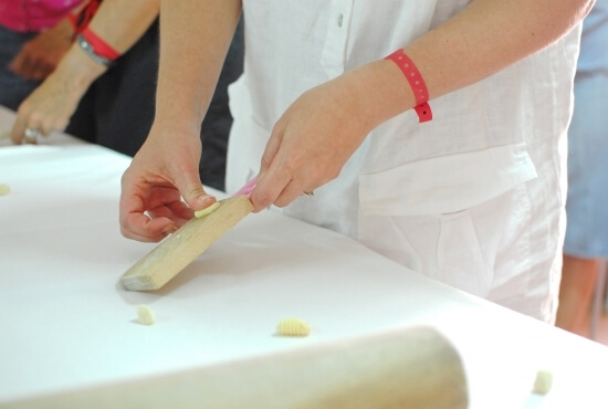 Resort guests prepare pasta