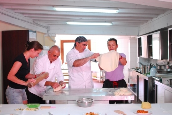 Chefs help guests to prepare the dough