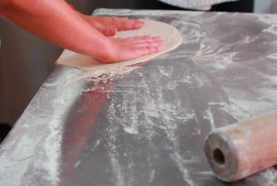 Girl prepares the dough