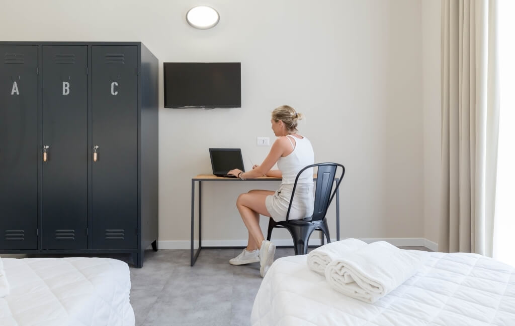 a girl working on the computer in the room