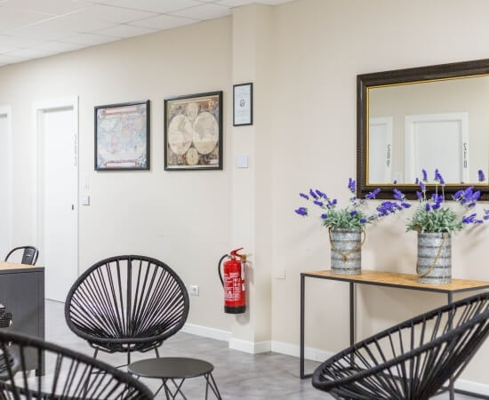 a small table with chairs in the common area