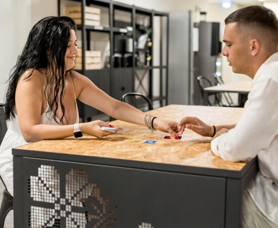 2 people at a table playing