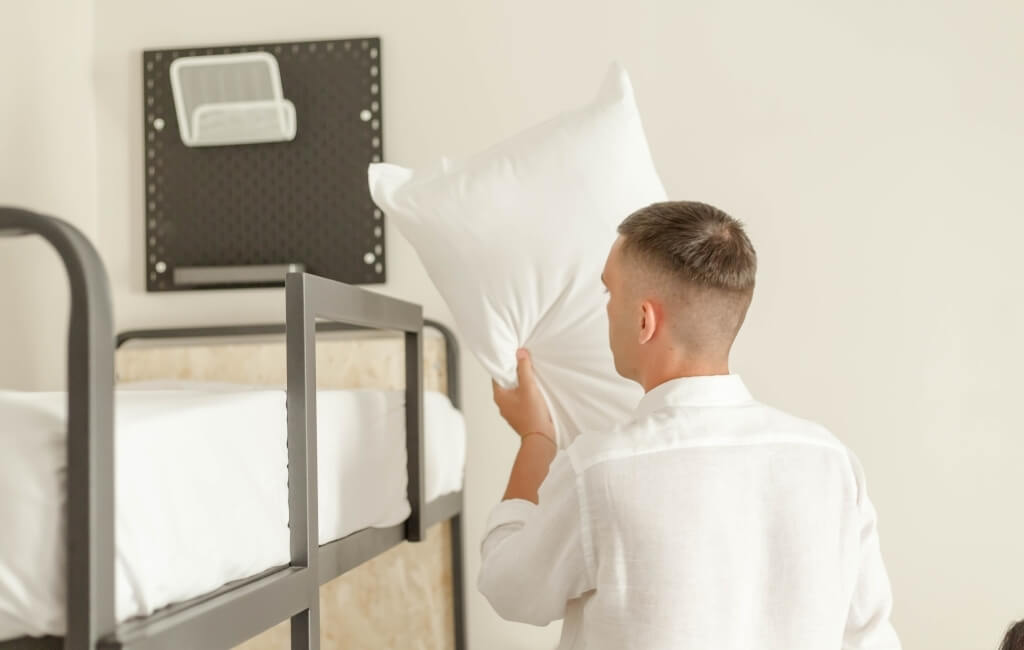 a boy making the bed