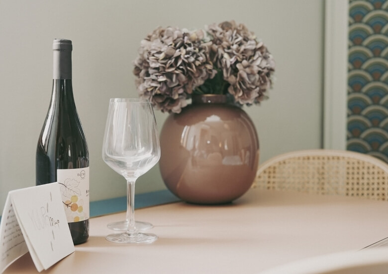 vase with flowers and bottle of wine studio queen