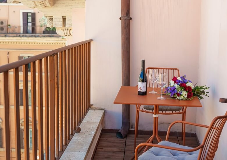 wine with two glasses on the terrace tables of the double room