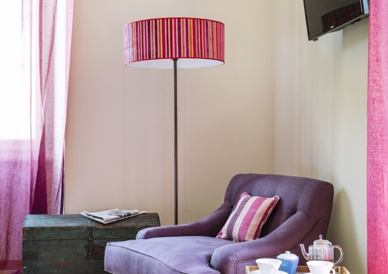 reading corner with lamp and armchair in the junior suite