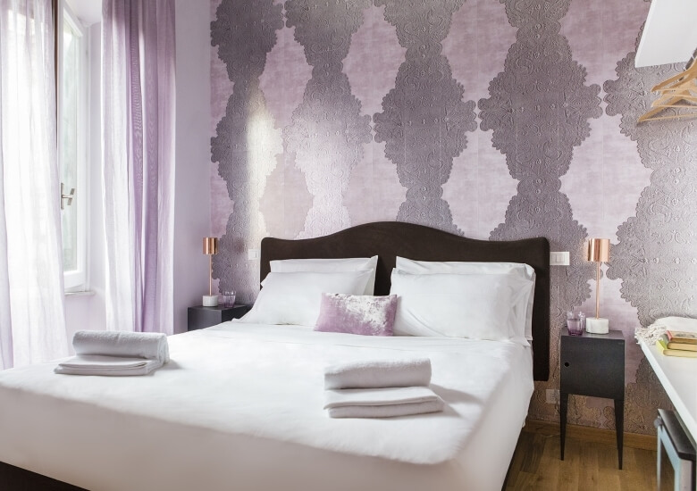 double bedroom with violet pink wallpaper 