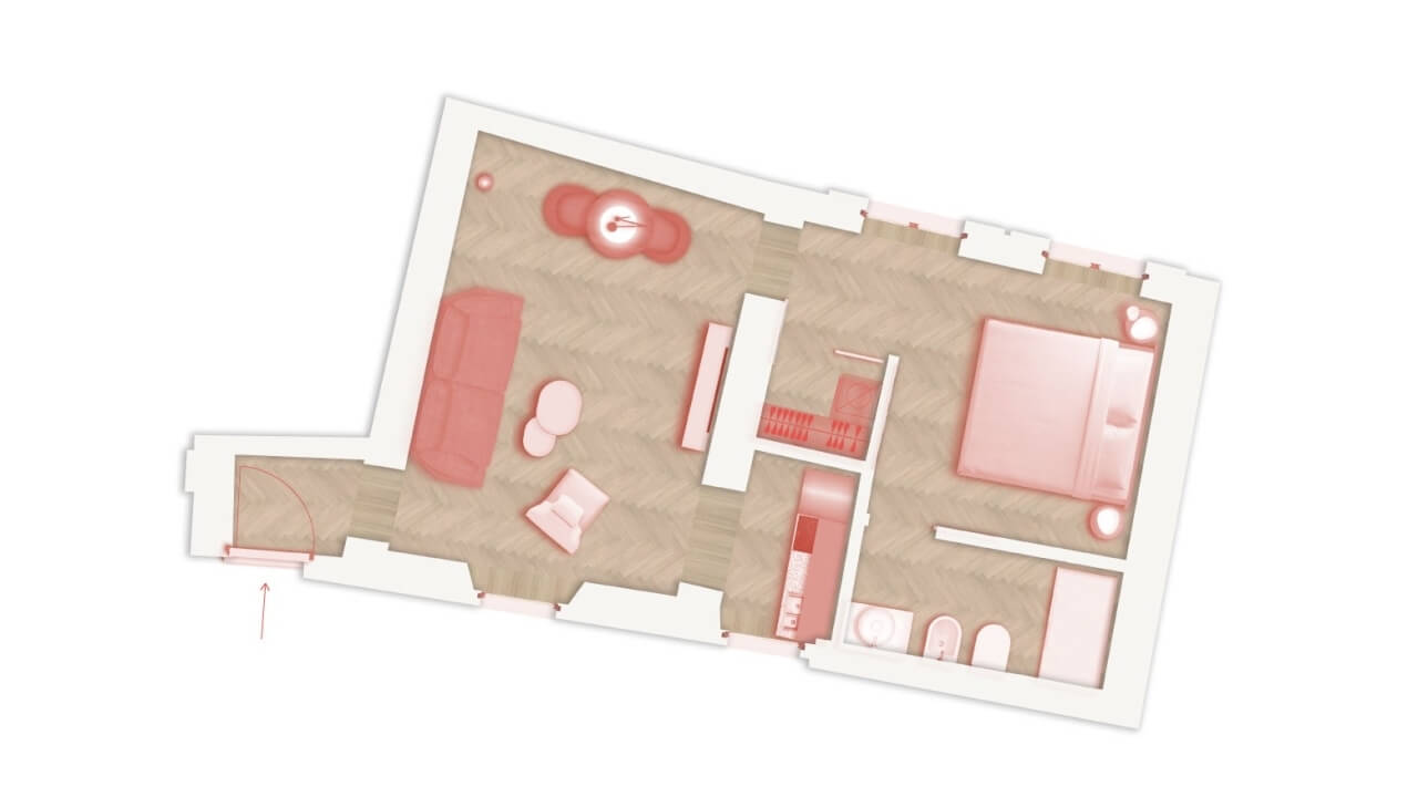 2-D floor plan in beige with red furniture accents, showing a couch, bed, desk, and bathroom, on a white background.