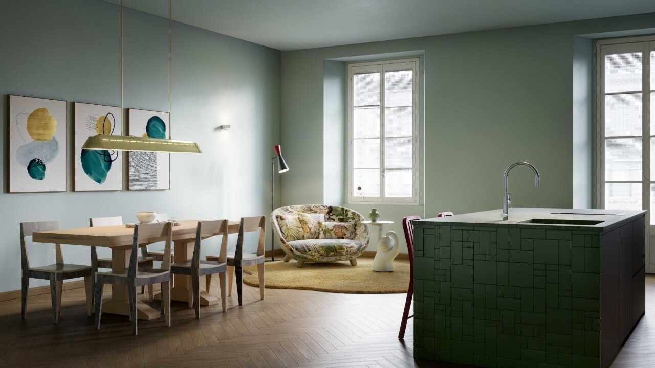 Modern kitchen and dining area with green island, red chair, floral couch, and abstract art in a light blue room.