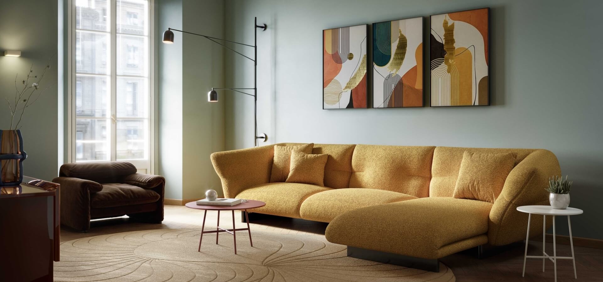 Modern living room with a yellow couch, brown chair, coffee table, abstract paintings, and natural light from a large window.