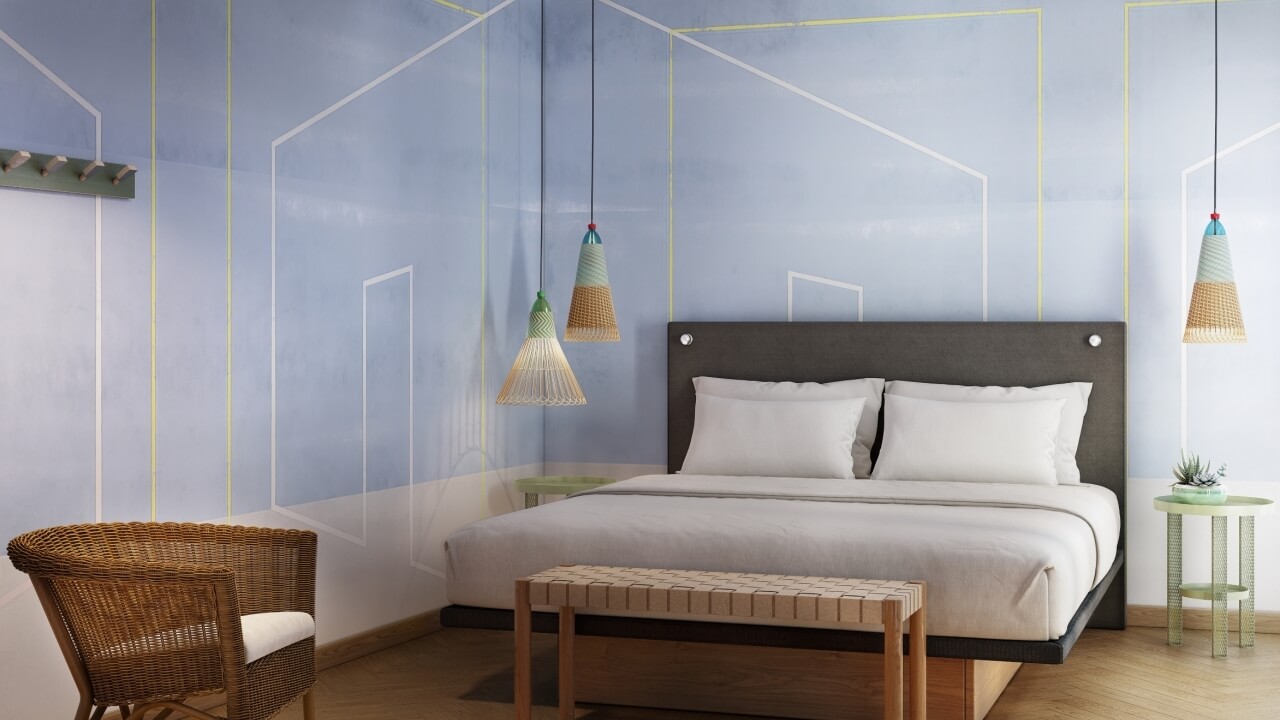 A cozy bedroom with a gray bed, nightstands, wicker chair, and light blue walls featuring decorative lines and a potted plant.